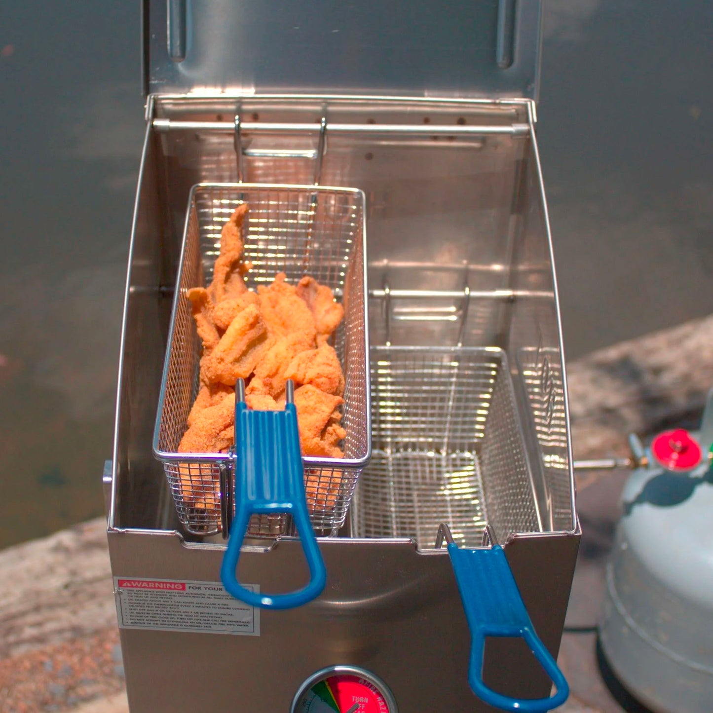 4-gal Stainless Bayou Fryer with fried fish in one of the baskets