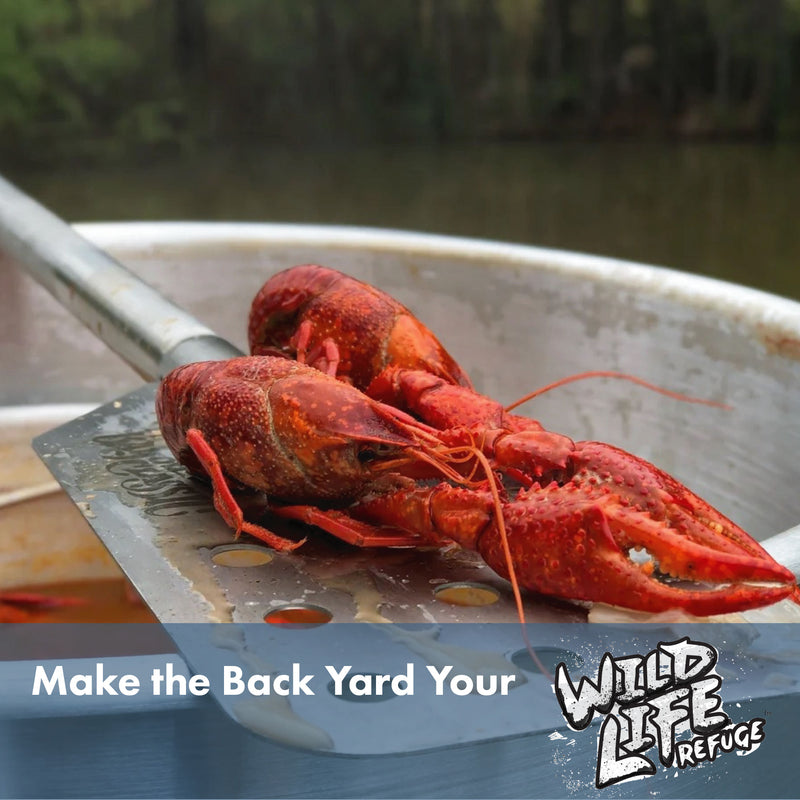 Stainless Paddle over a pot holding cooked crawfish with text that reads Make the Back Yard Your Wild Life Refuge