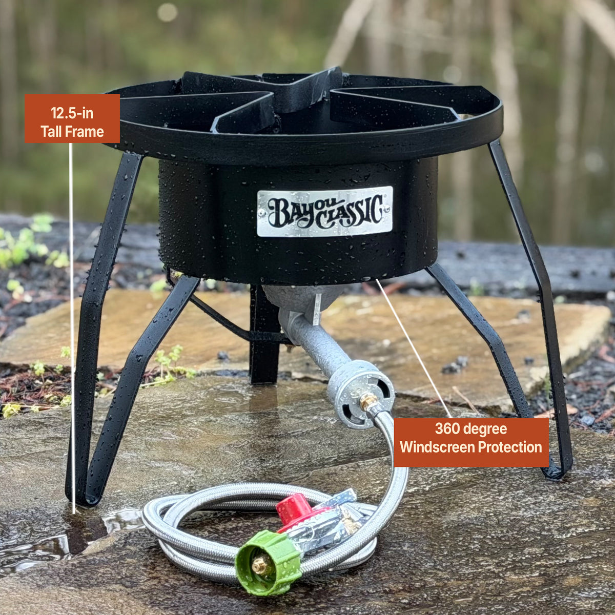 Steel outdoor cooker in outdoor setting showing measurements of 12.5-in Tall Frame and 360 degree Windscreen Protection