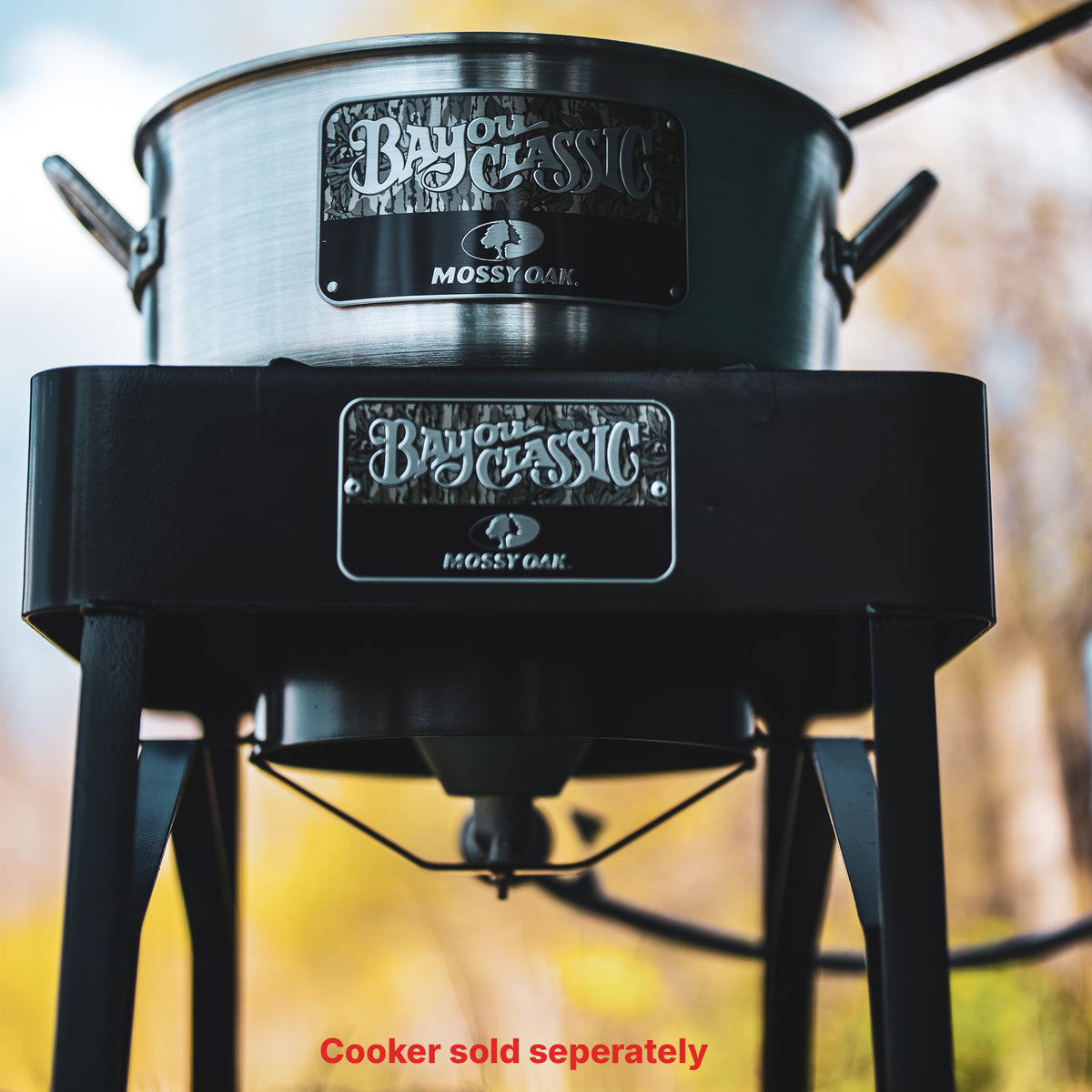 Aluminum Fry Pot on an outdoor cooker both with the Bayou Classic Mossy Oak logo plate