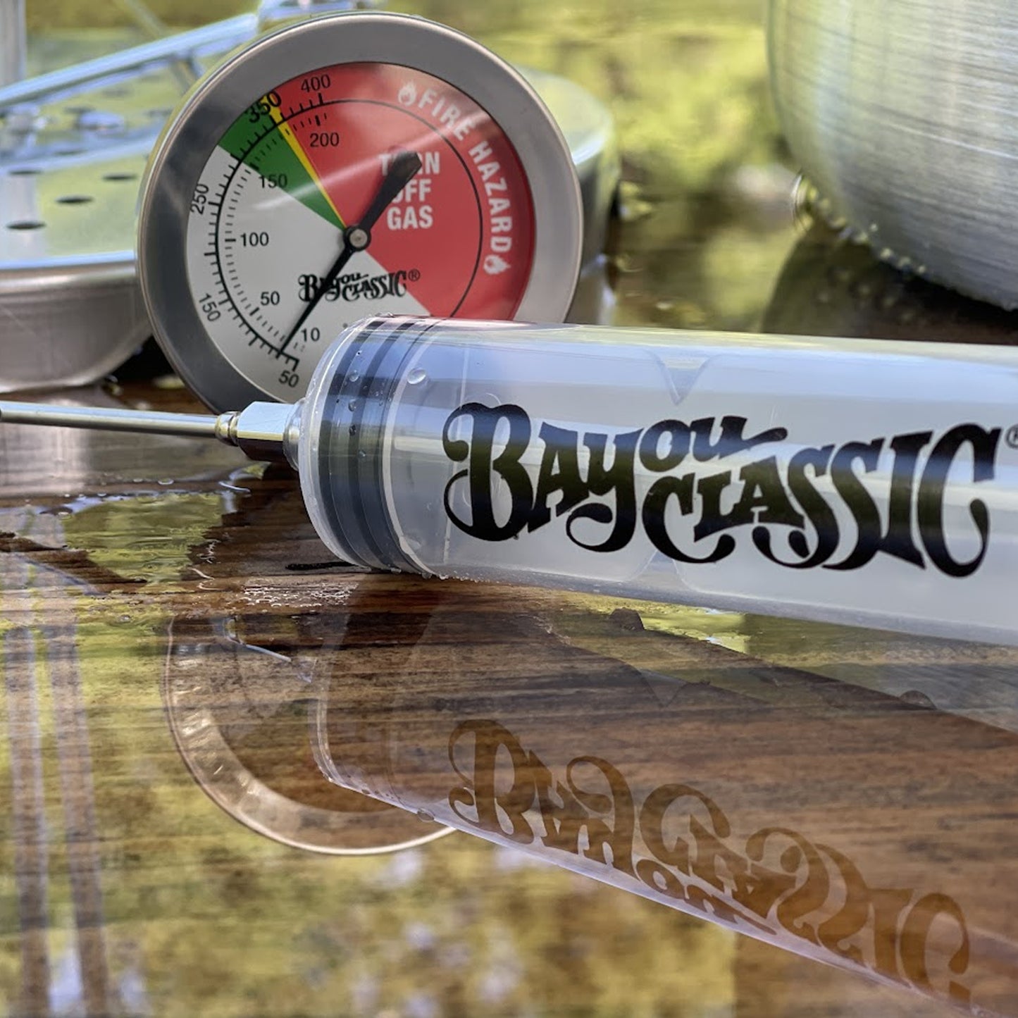 Bayou Classic plastic seasoning injector in front of deep fry thermometer