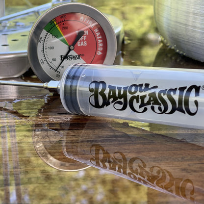 Bayou Classic plastic seasoning injector in front of deep fry thermometer