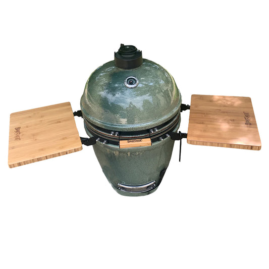Green ceramic kamado style grill with bamboo shelves on a white background