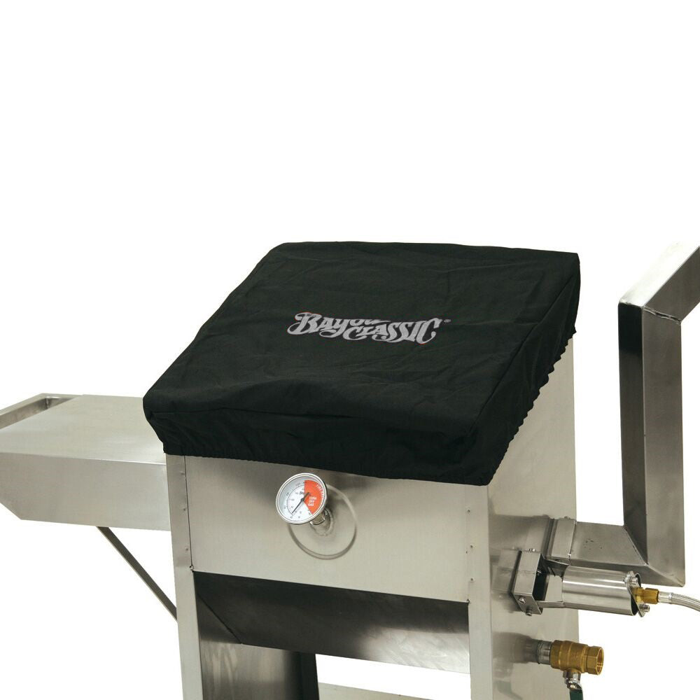 Black canvas lid cover fitted on a 9-gal Bayou Fryer with Bayou Classic logo on a white background