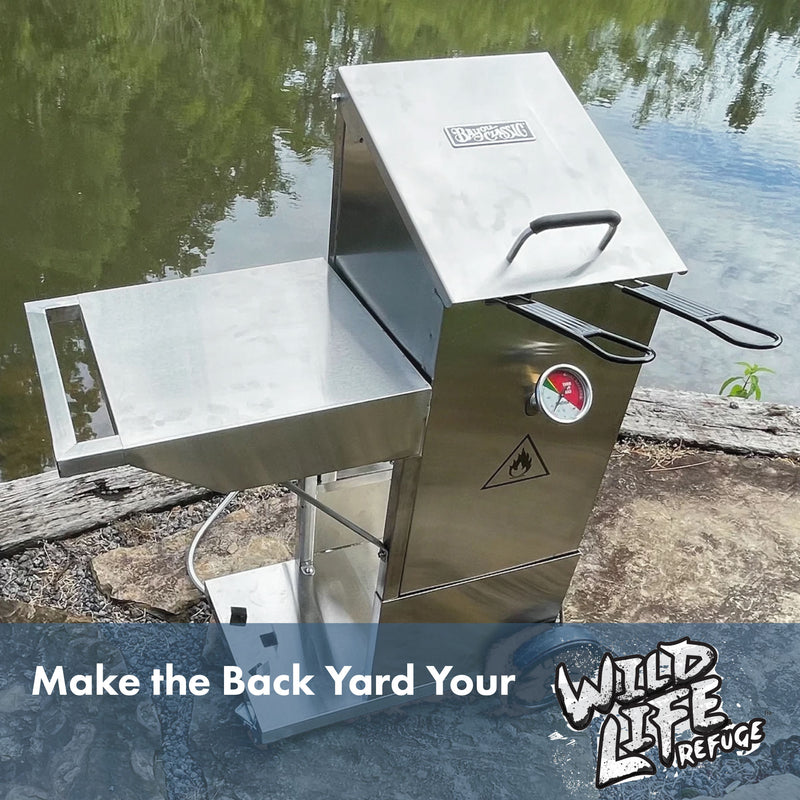 Stainless Bayou Fryer with Cart outside by a body of water and text that reads Make the Back Yard Your Wild Life Refuge