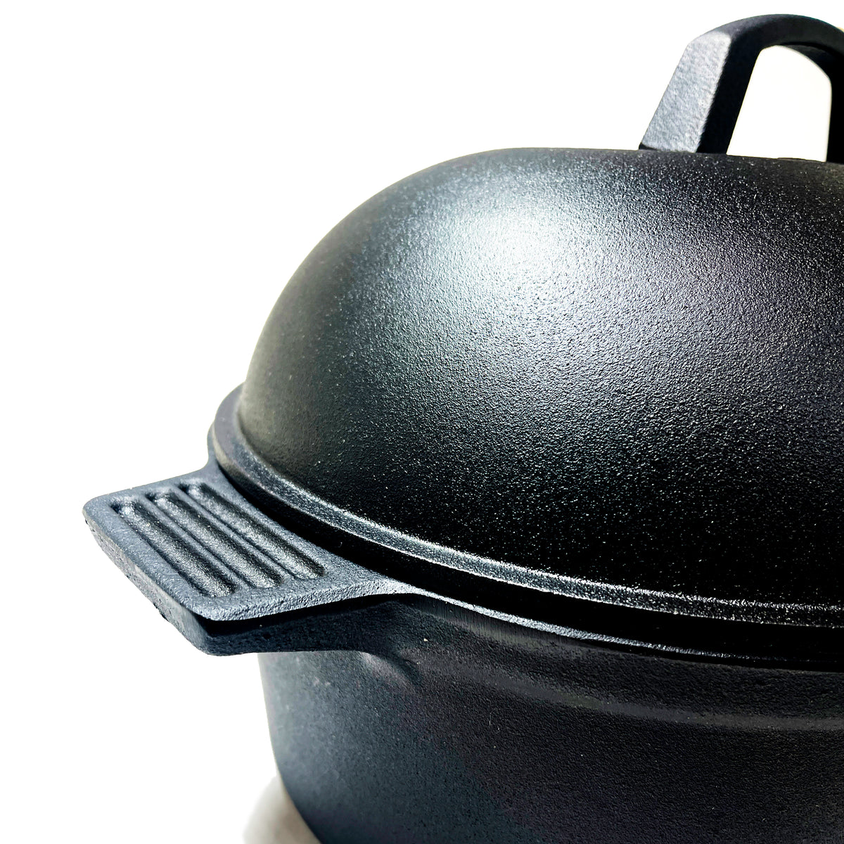 Close up of oval roaster with lid on a white background