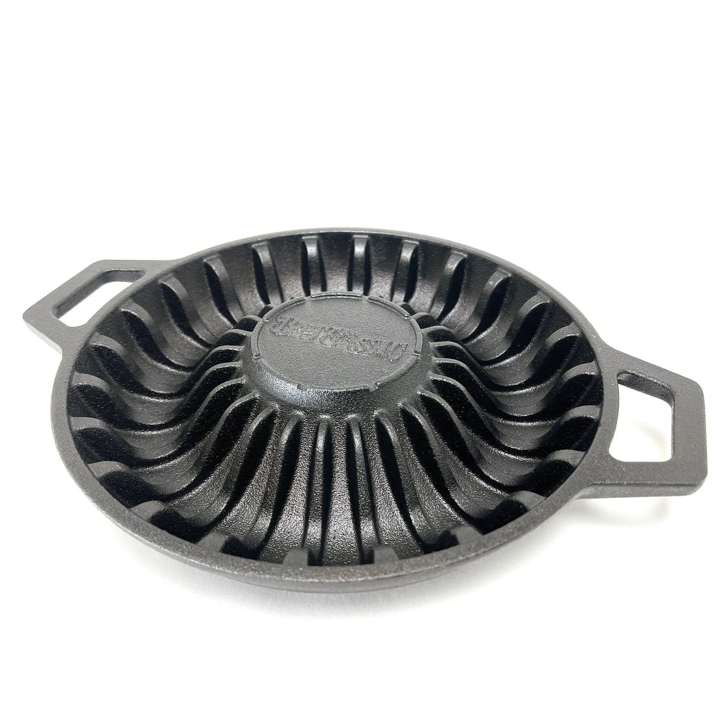 A black cast iron shrimp pan with ridged pattern to hold shrimp and two handles on a white background
