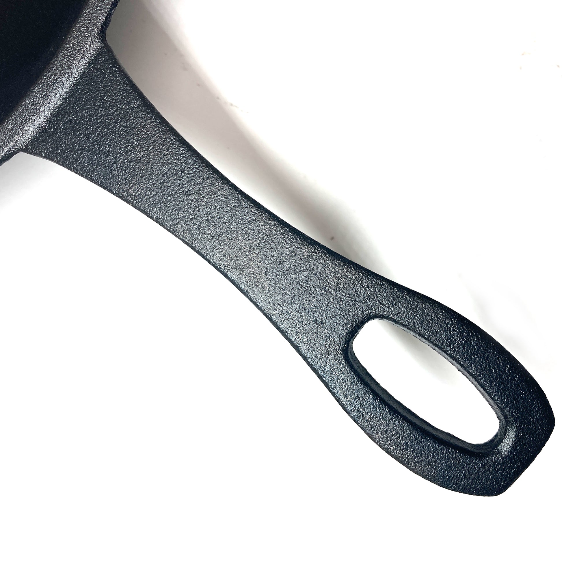 Close up of Cast Iron Skillet handle on a white background