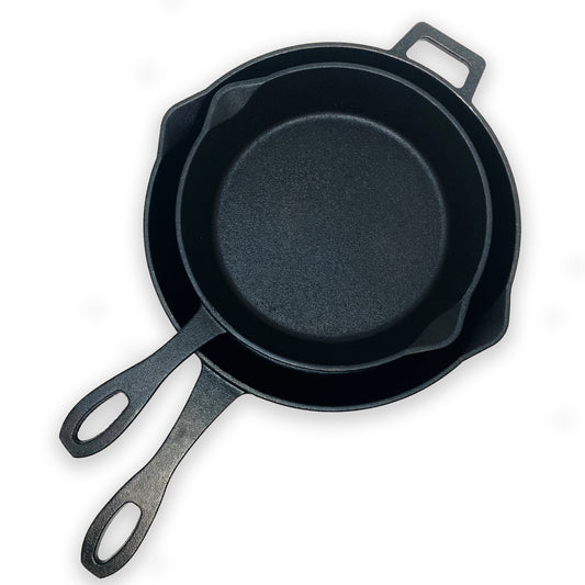 Two cast iron skillets on a white background
