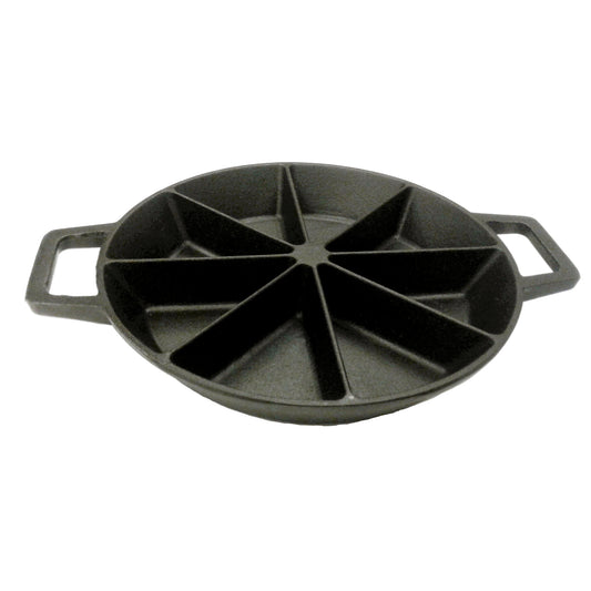 A black cast iron wedge cornbread skillet with side loop handles on a white background