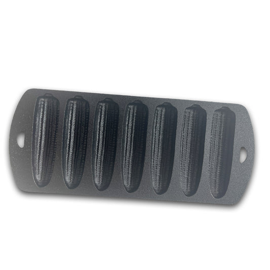 Cast iron cornbread pan with seven cornstick molds on a white background.