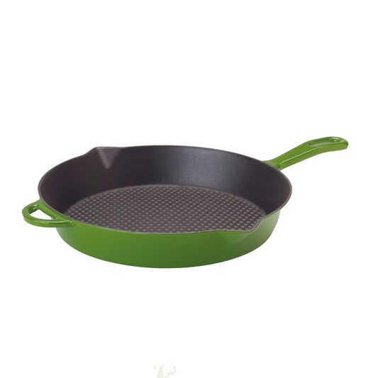 Green enameled cast iron skillet on a white background