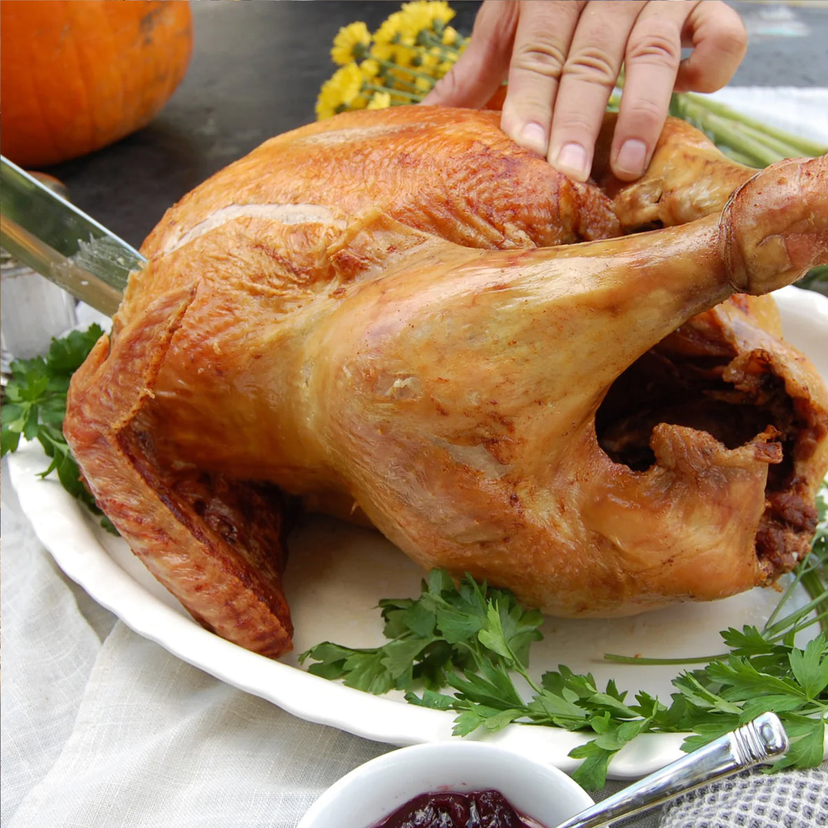 Close up of person carving a fried turkey
