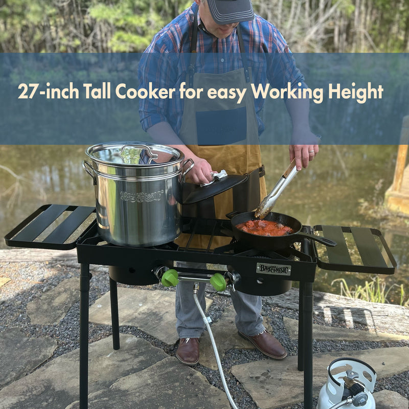 Person cooking outdoors using a dual burner outdoor patio stove with a stainless stockpot and cast iron skillet.  Text reads 27-in tall cooker for easy working height