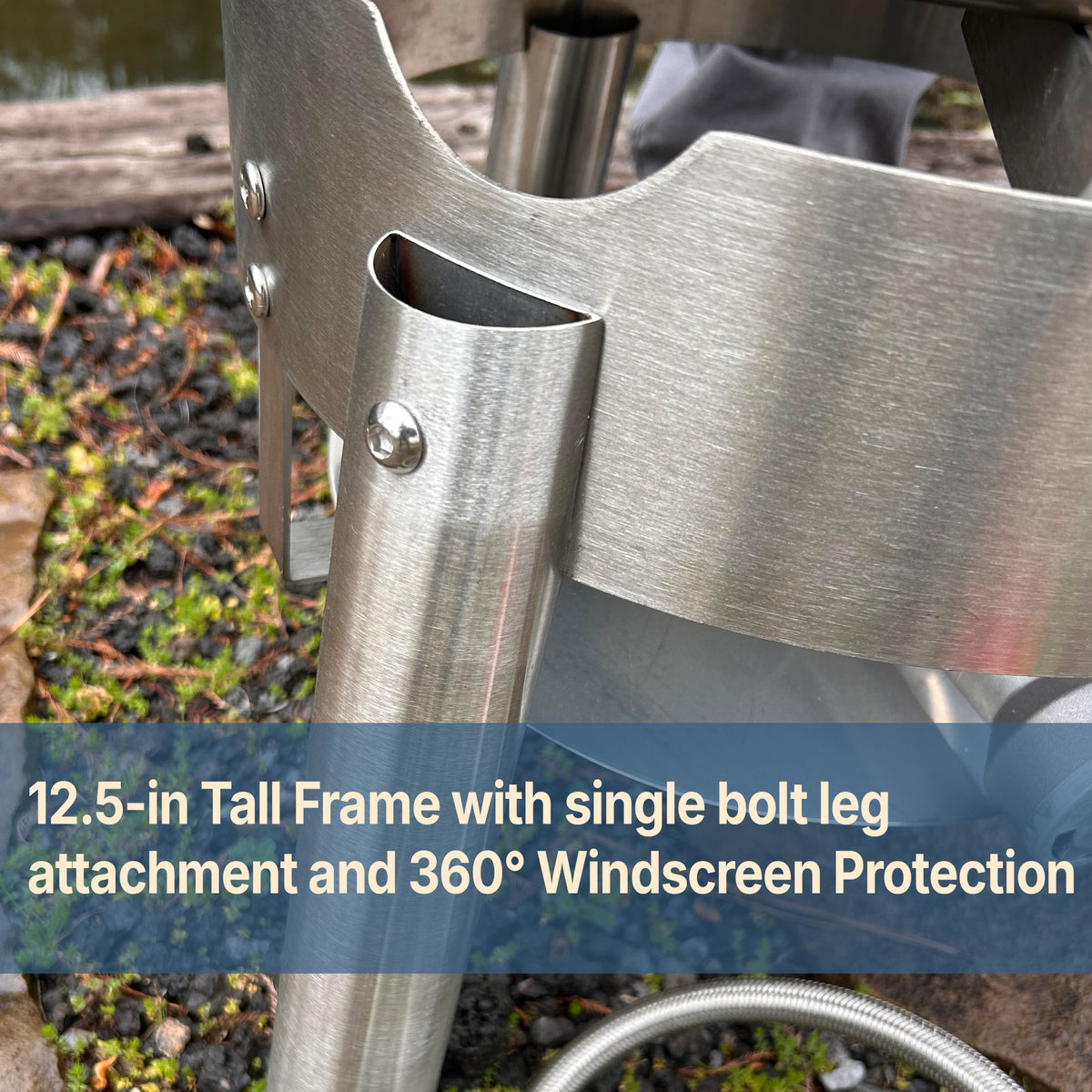 Close up image of Stainless Cooker with text that reads 12.5-in tall frame with single bolt leg attachment and 360 degree windscreen protection