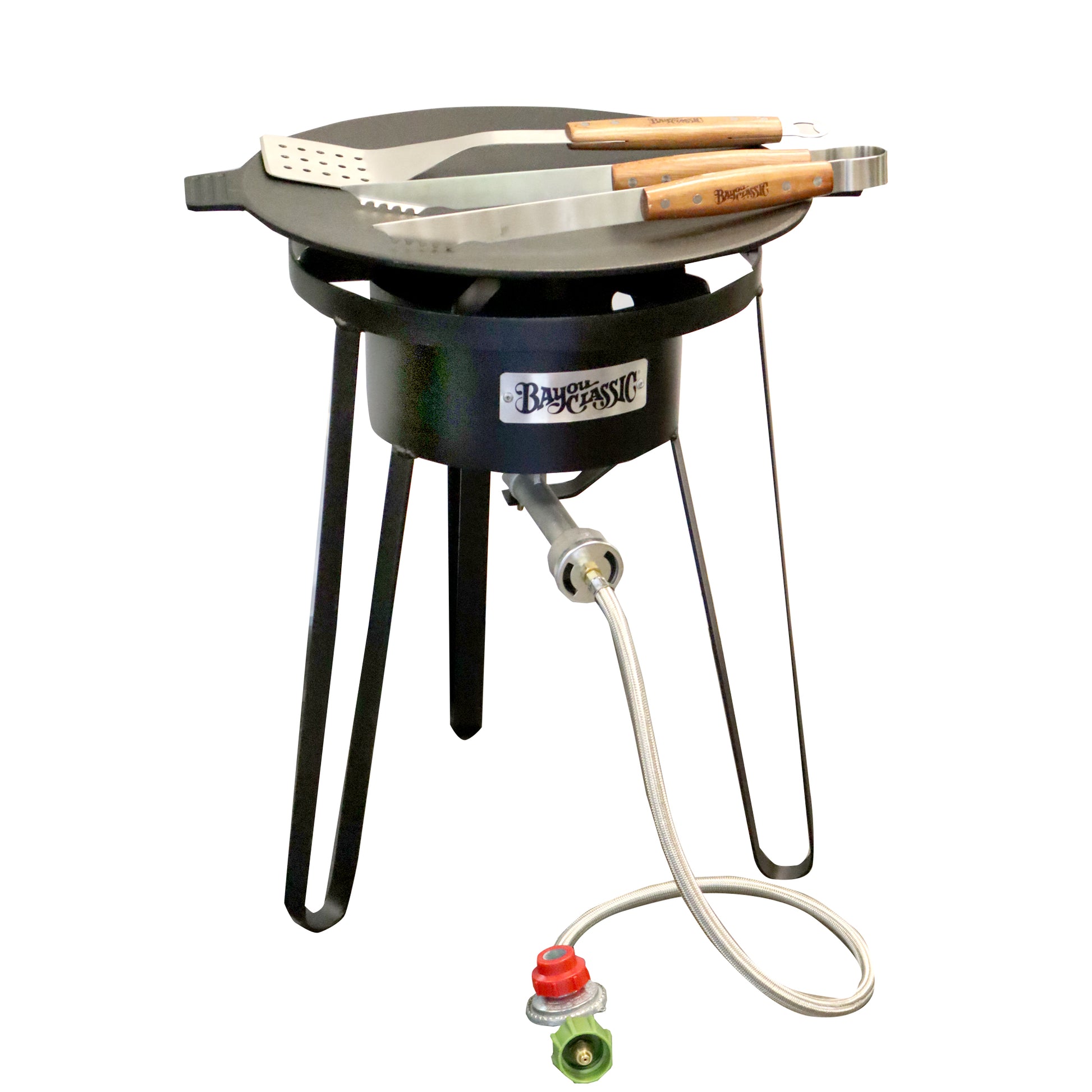A cast iron discada cooker kit with an outdoor cooker, cast iron discada, spatula, and tongs on a white background