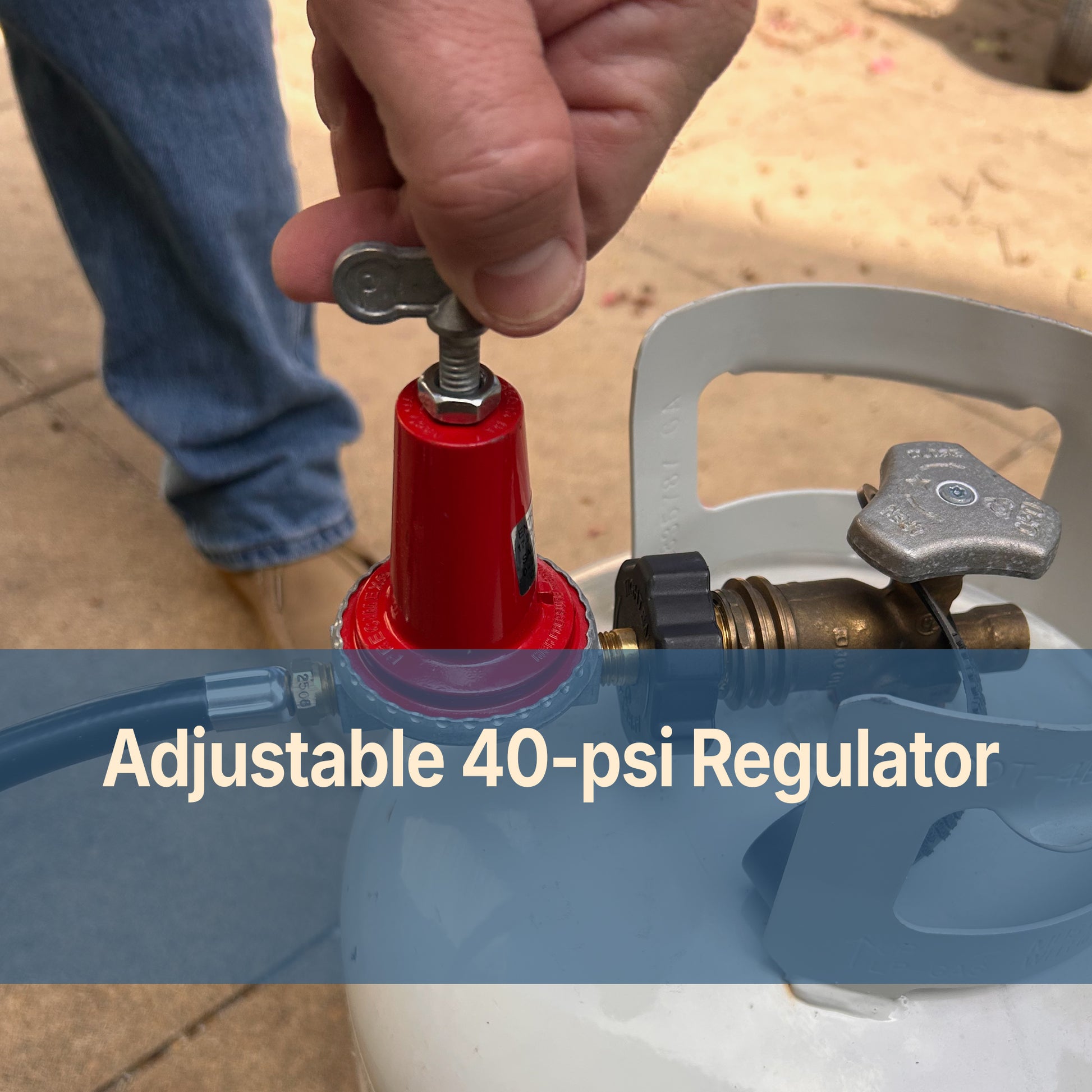 Person adjusting a red adjustable 40-psi regulator on a white propane tank.