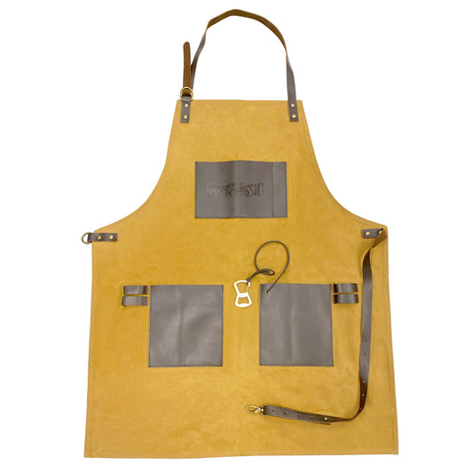 Waxed canvas apron with leather straps and pockets on a white background