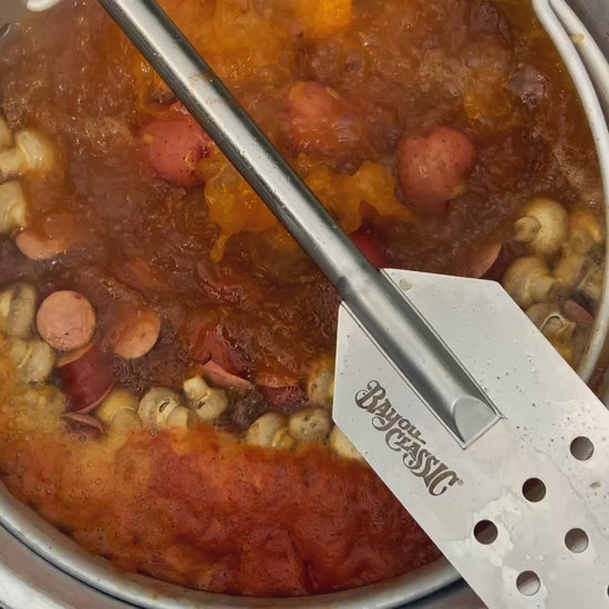 Bayou Classic stock pot at a rolling boil with sausage, potatoes and mushrooms