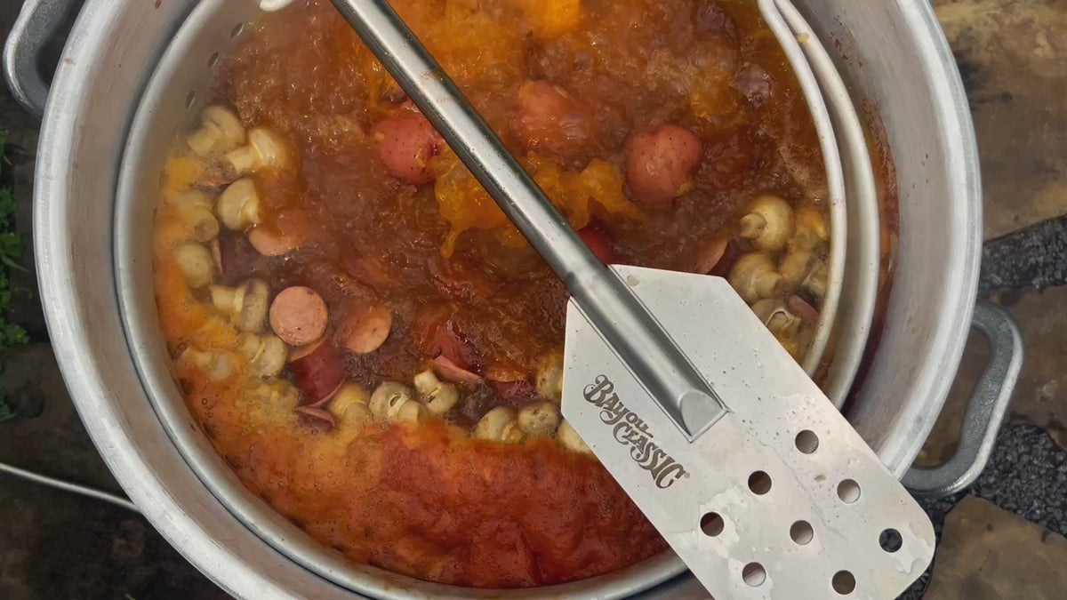 Bayou Classic stock pot at a rolling boil with sausage, potatoes and mushrooms