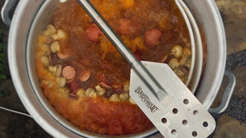 Bayou Classic stock pot at a rolling boil with sausage, potatoes and mushrooms