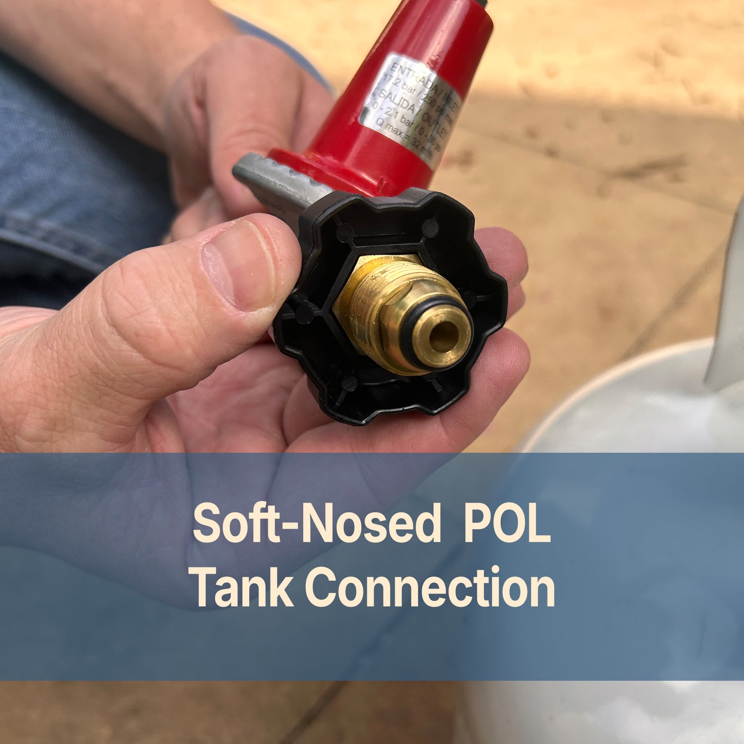 Hand holding a soft-nosed POL tank connection with text that reads soft-nosed POL Tank Connection