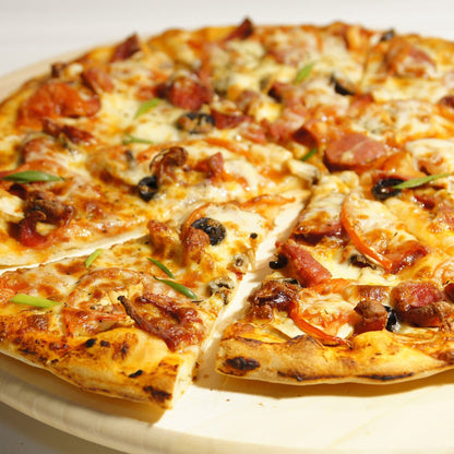 Cooked pizza on a ceramic pizza stone