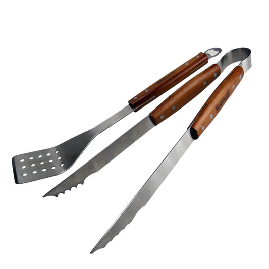 A set of stainless steel grill tools with hardwood handles, including a spatula with a slotted end and a bottle opener, and a pair of tongs with scalloped edges.