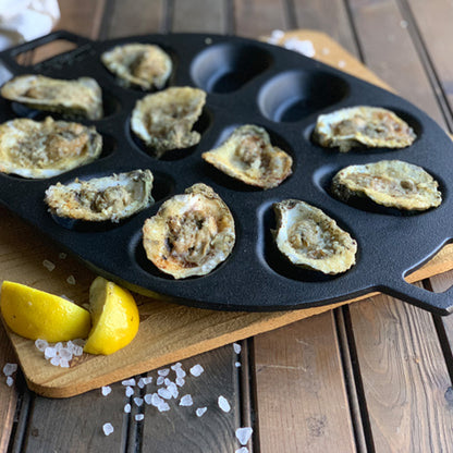 Chargrilled oysters in a cast iron oyster grill pan 